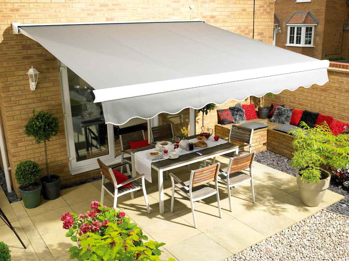 Large retractable awning providing shade over a garden patio